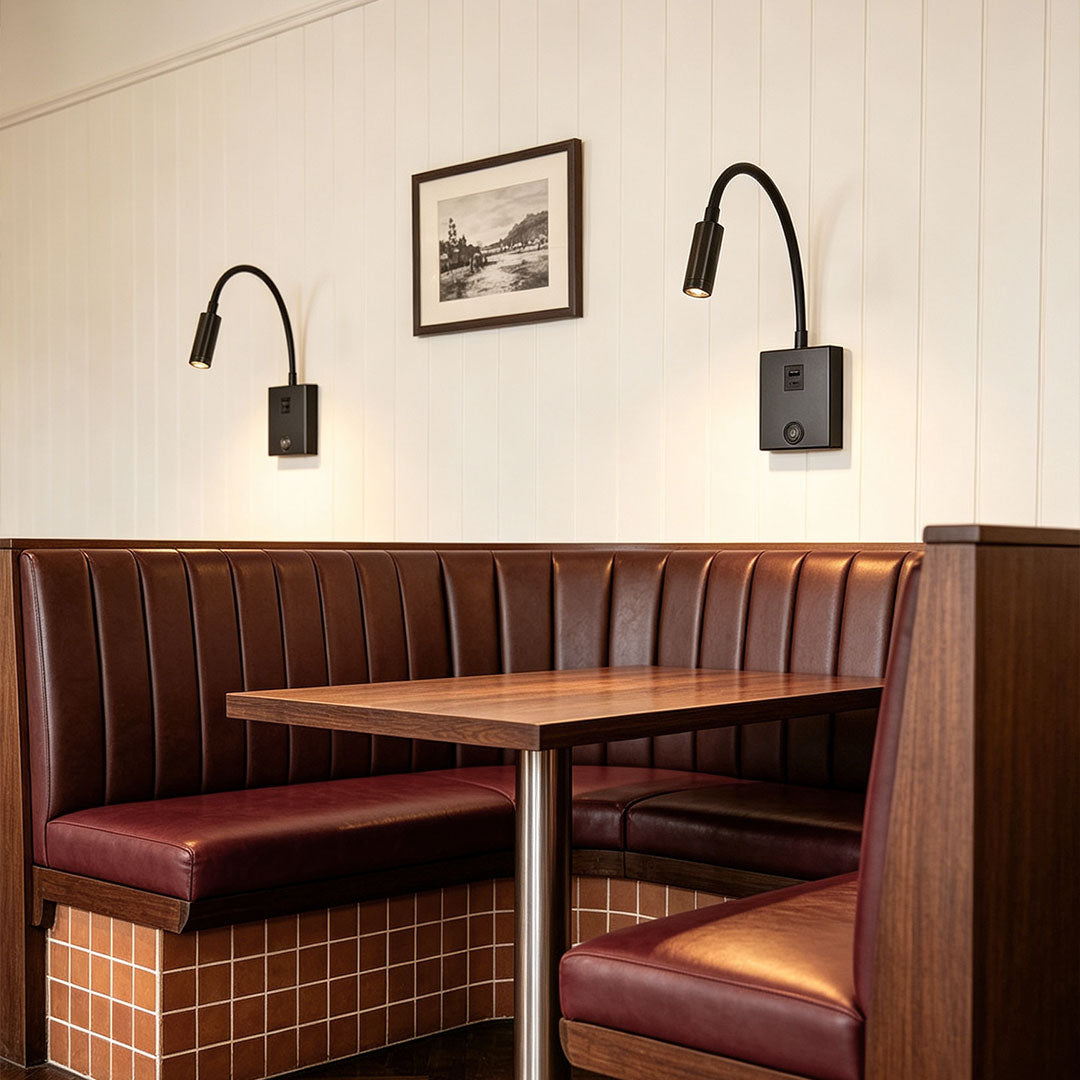 Stylish bedside reading wall lights illuminating booth seating area with warm focused LED lighting.