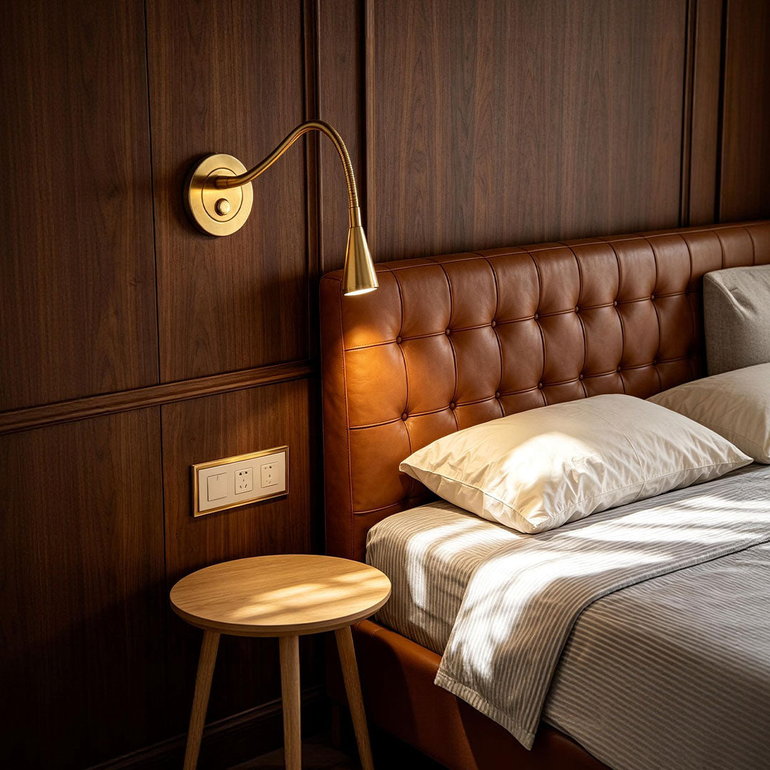 Bedside wall light with swing arm in luxury hotel bedroom interior.