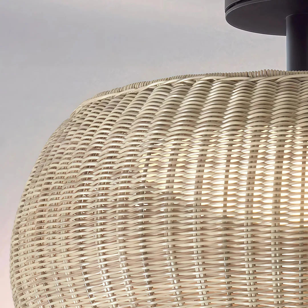 Close-up of the textured beige wicker shade on a woven flush mount light.