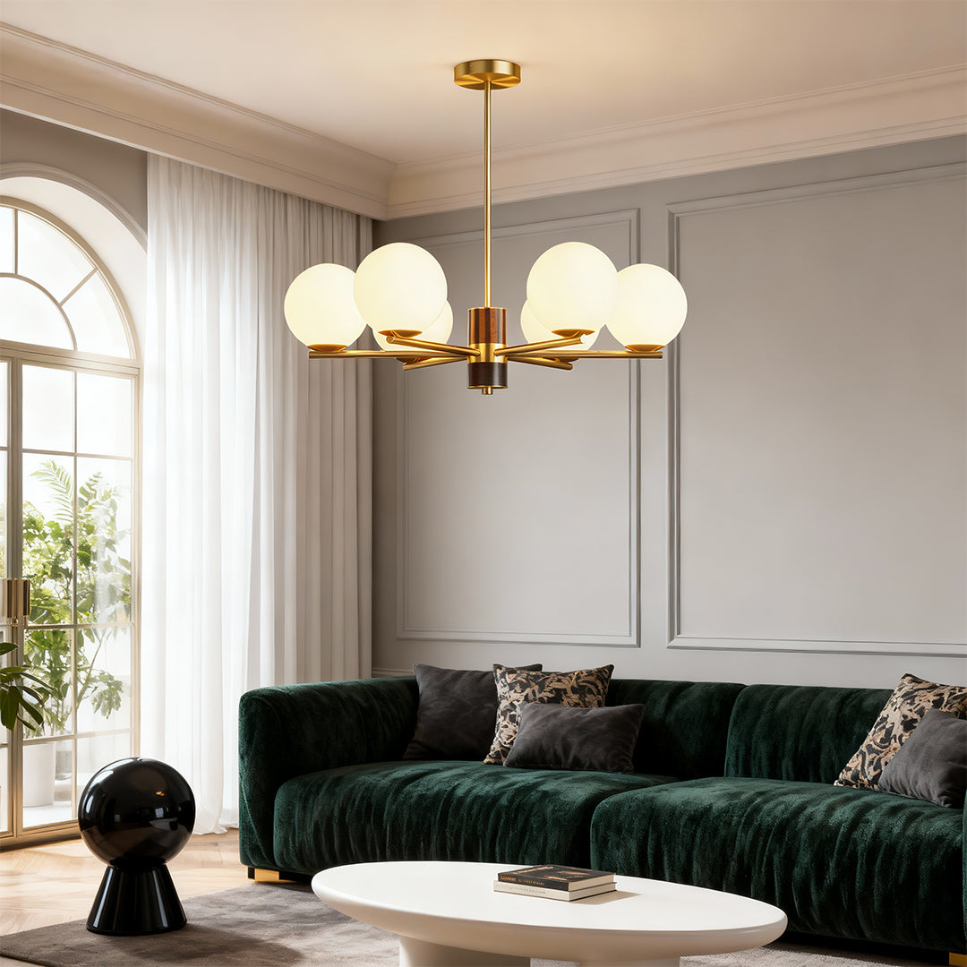 Modern luxury chandeliers above green velvet sofa in sophisticated contemporary interior