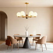 Modern luxury chandeliers creating focal point in minimalist dining room with round table