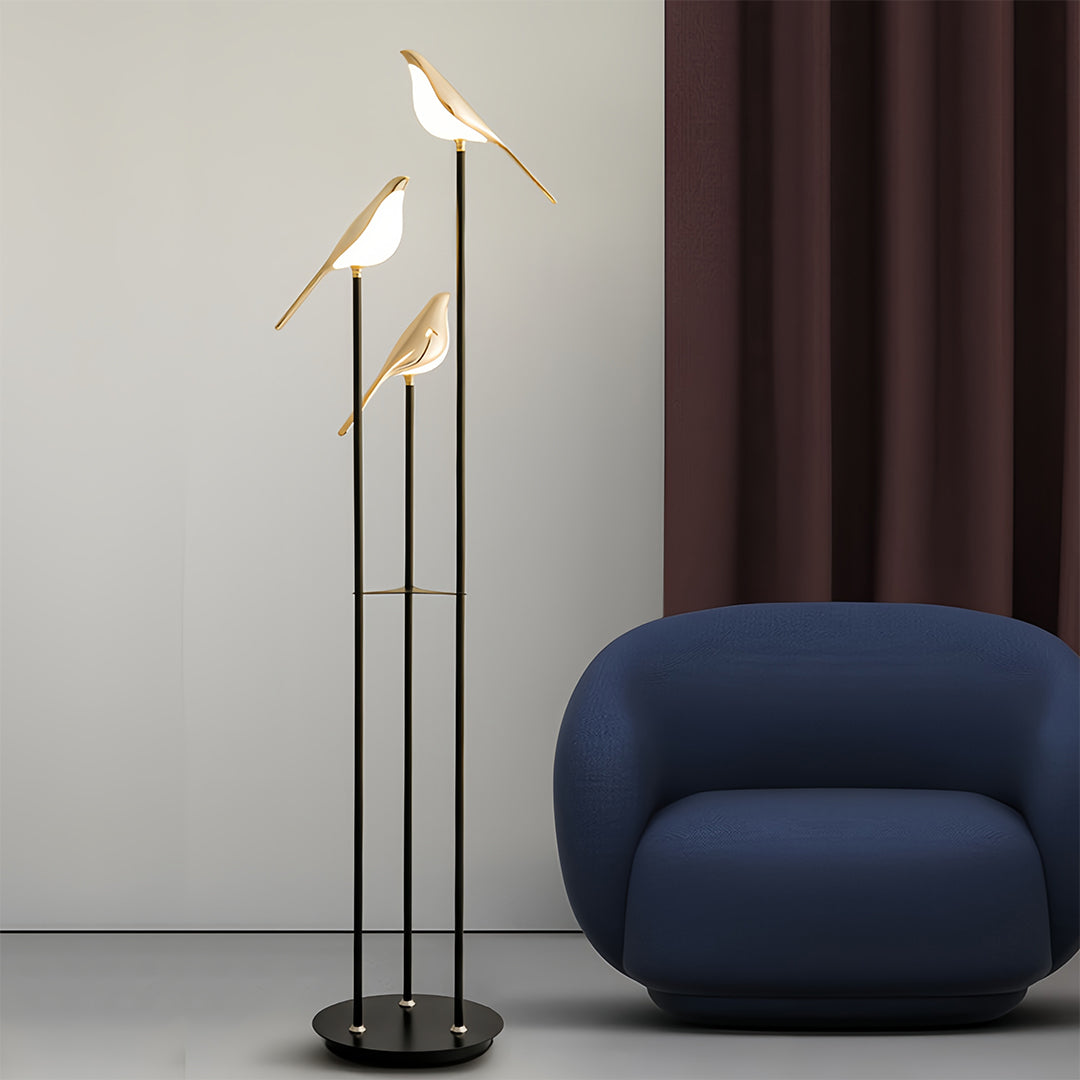 Bird floor lamp beside blue chair in stylish interior with rich textures and sophisticated color palette
