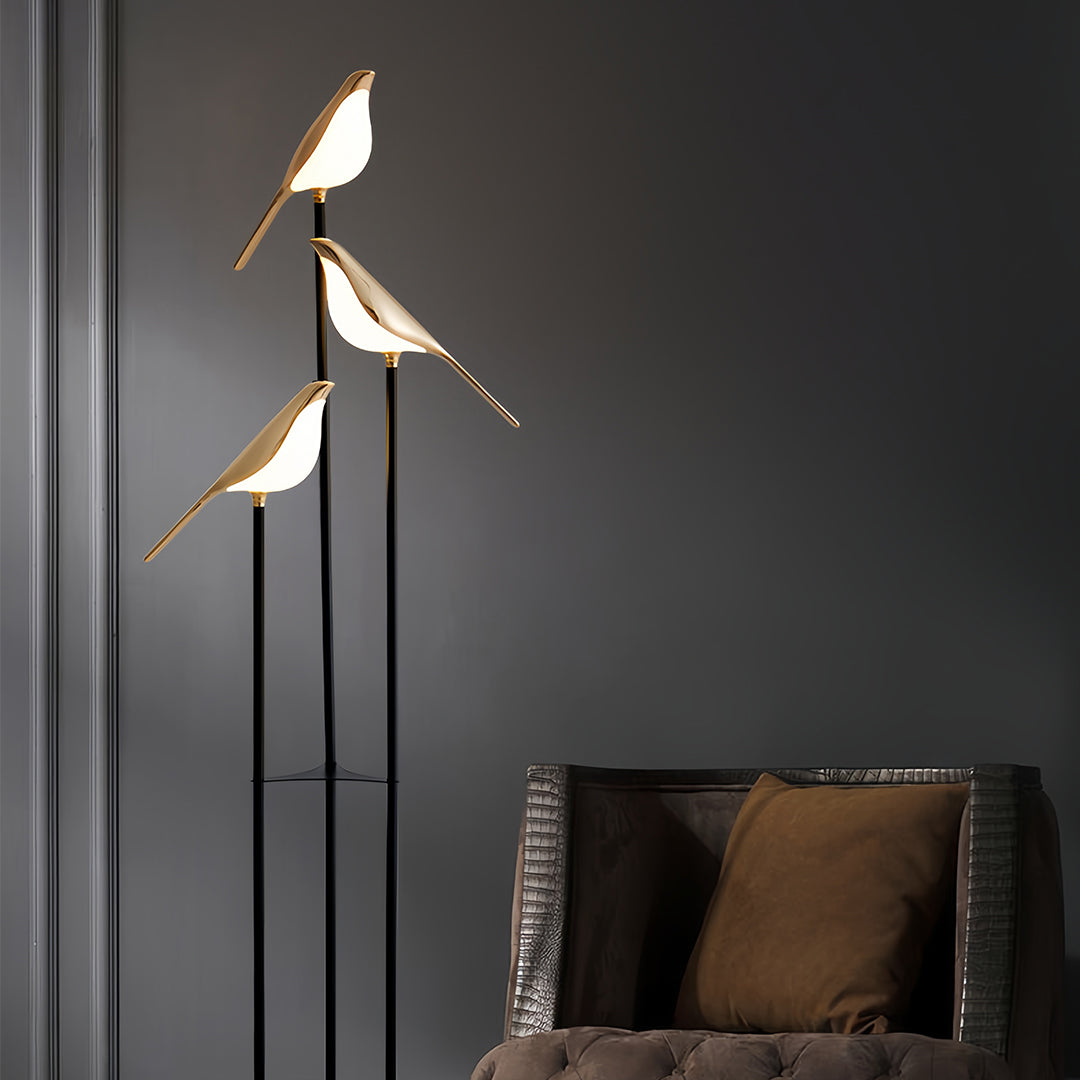 Bird floor lamp illuminating modern living room with dark walls creating ambient lighting and decorative focal point