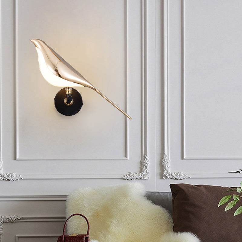 Bird wall light mounted on a classic wall panel in a cozy seating area
