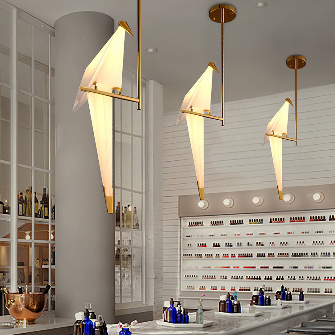 Bird wall light in a restaurant, adding charm to the wooden tables and chairs.