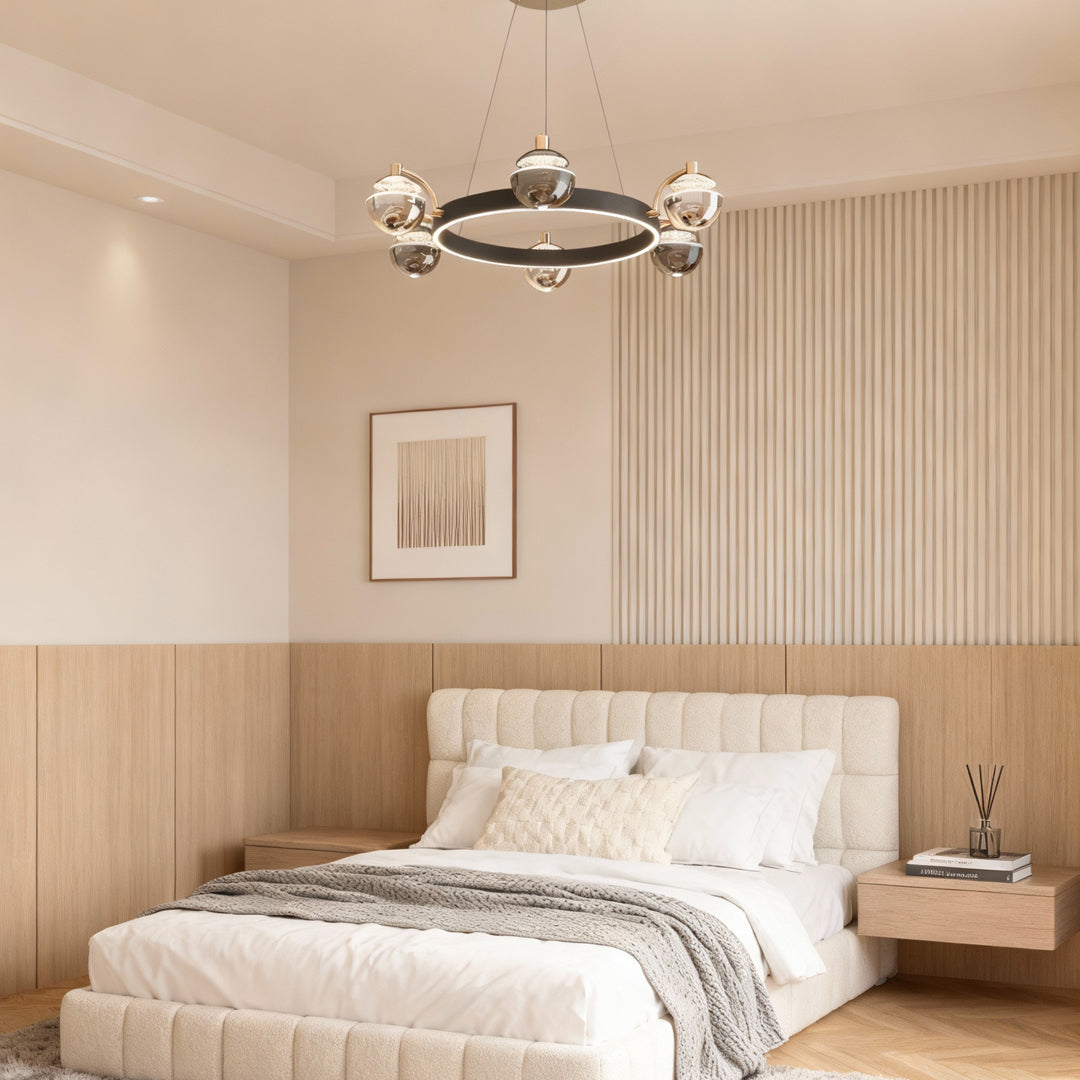 Black and gold modern chandelier illuminating bedroom with wood slat accent wall and upholstered headboard creating warm ambiance