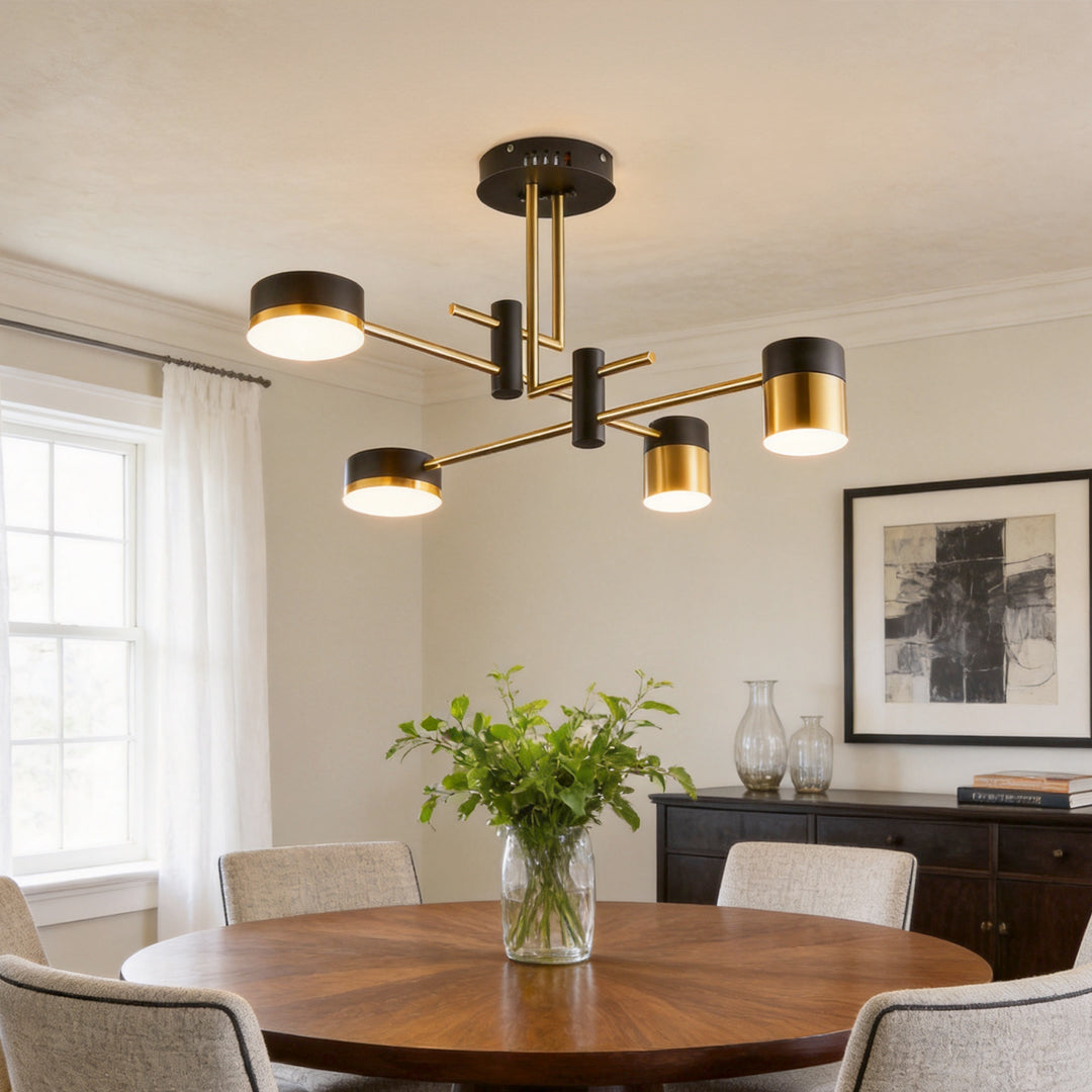 Black and gold sputnik ceiling light illuminating a dining area with a round table and minimalist decor.