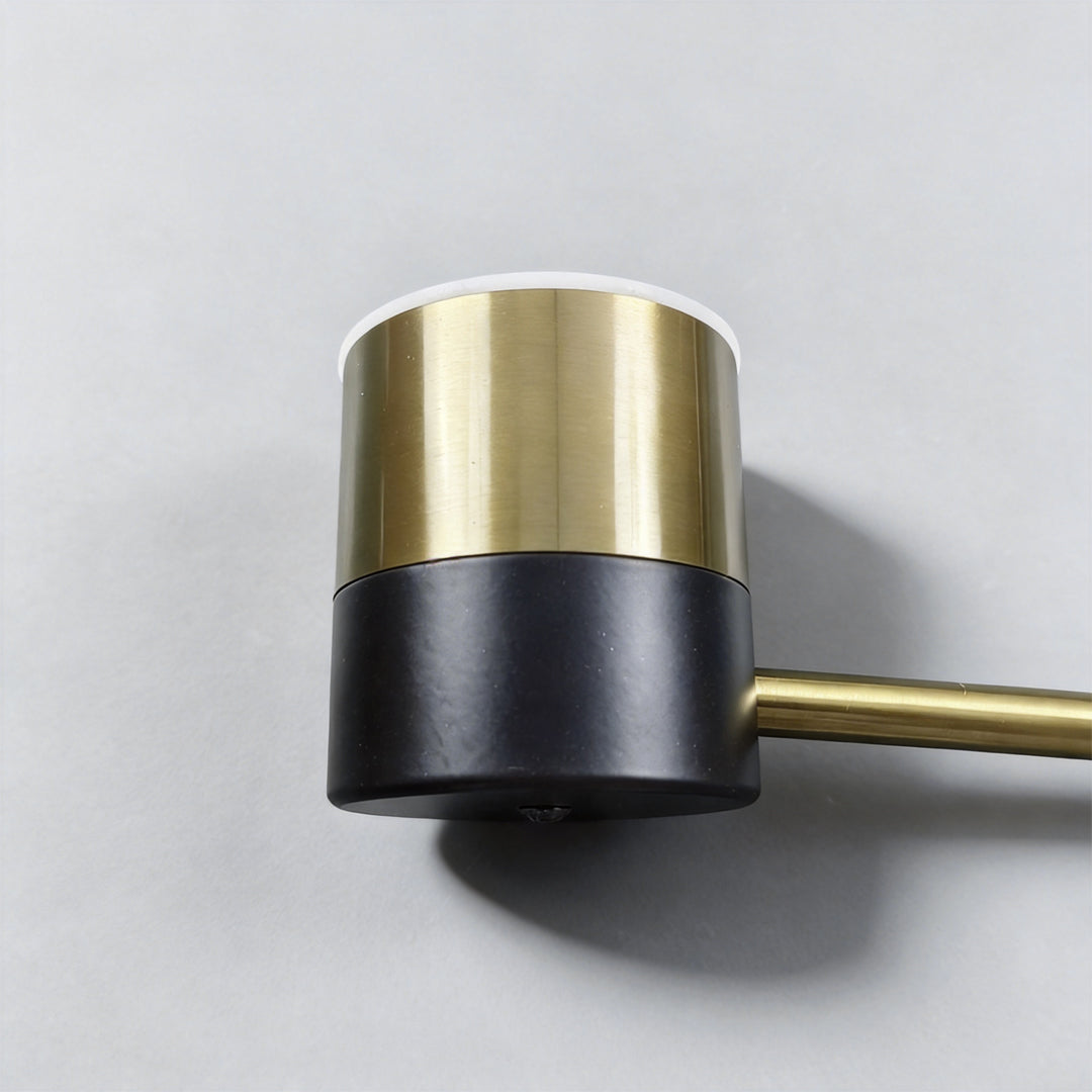 Detailed view of cylindrical light head with black and gold finish on a black and gold sputnik ceiling light.