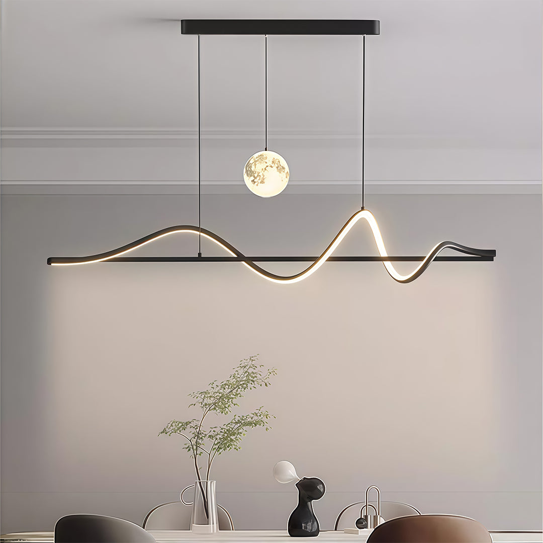Black art deco pendant light with angular wave pattern and spherical accents mounted above grey credenza.