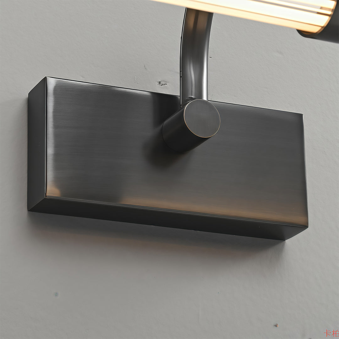 Black bathroom vanity wall light mounted on grey surface showing side profile and illumination pattern.