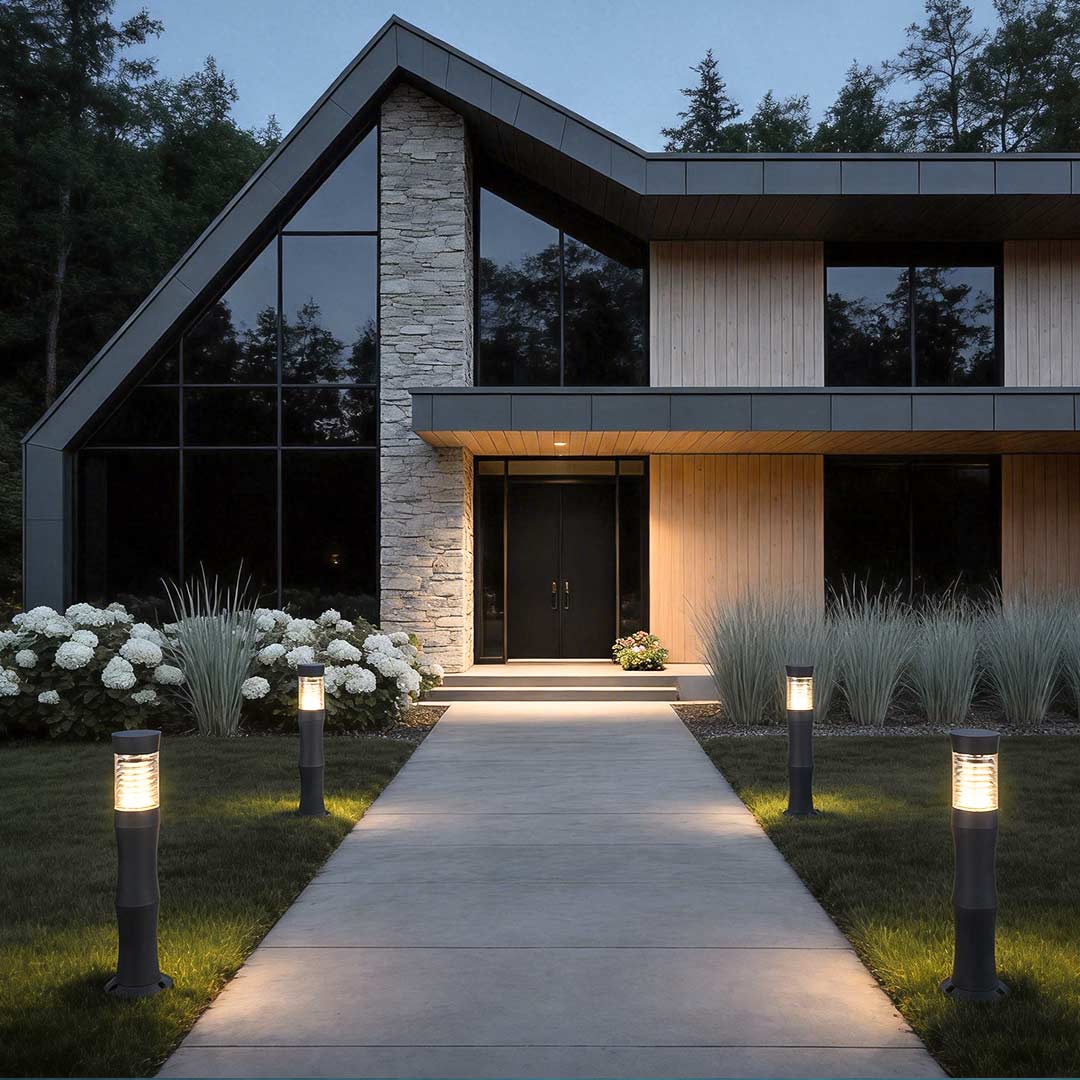 Black bollard garden lights enhancing a contemporary house entrance with soft light.