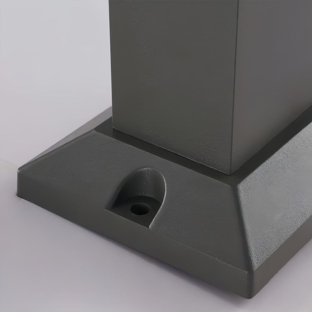 Black bollard light base showing surface mounting detail