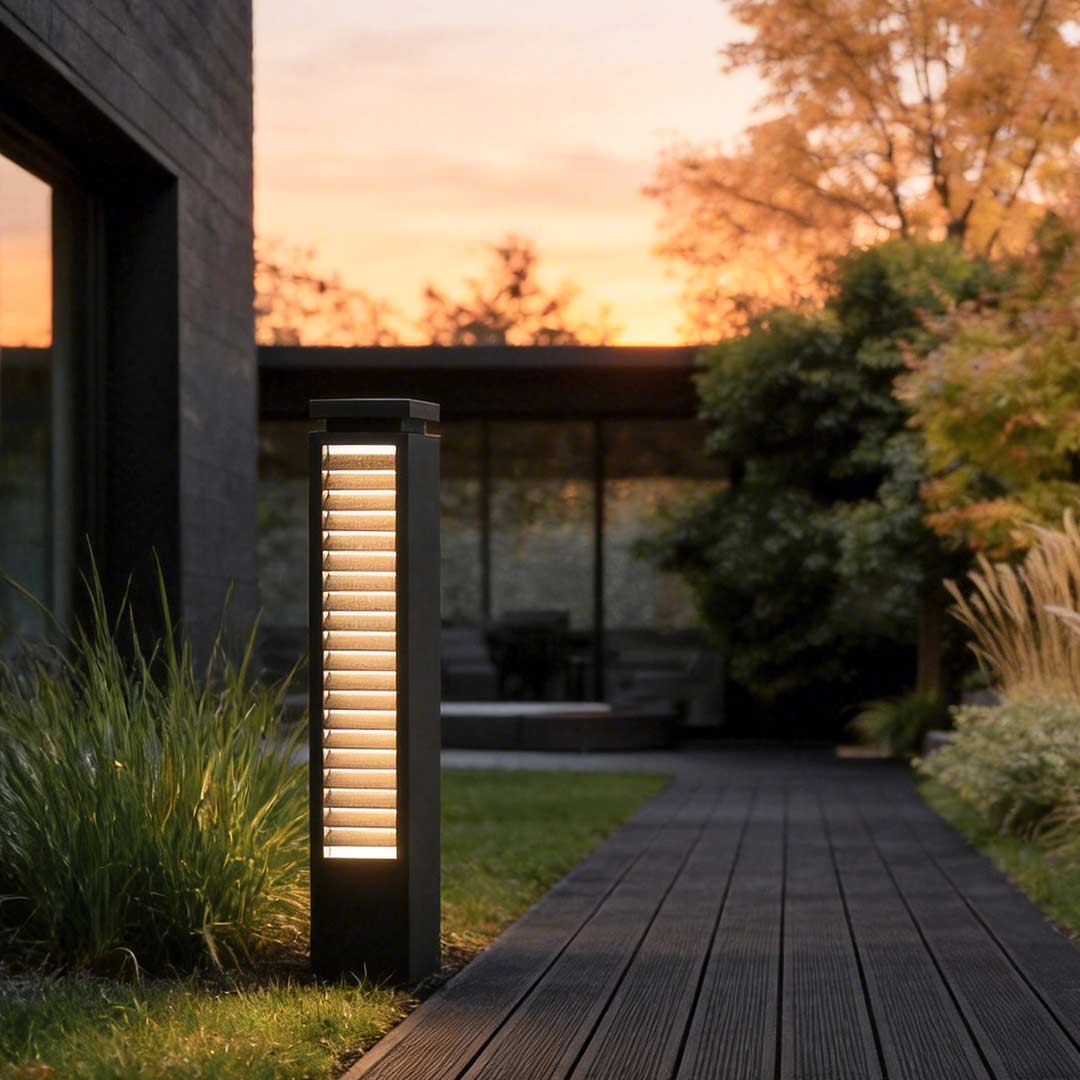 Black bollard light enhancing a contemporary outdoor walkway at sunset.