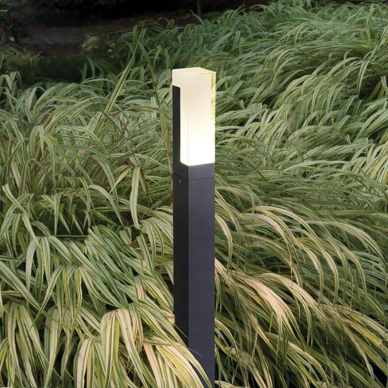Black bollard lights installed along grass landscaping