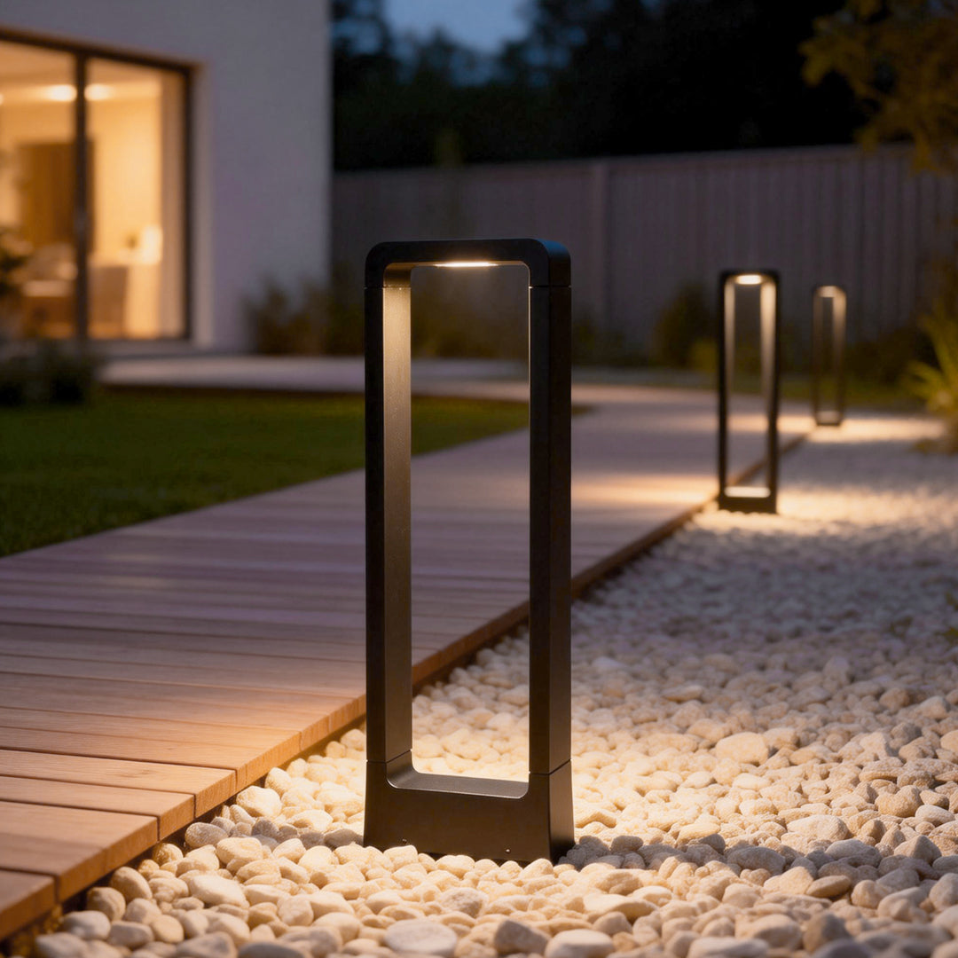 Black bollard lights providing subtle light on a modern outdoor staircase.
