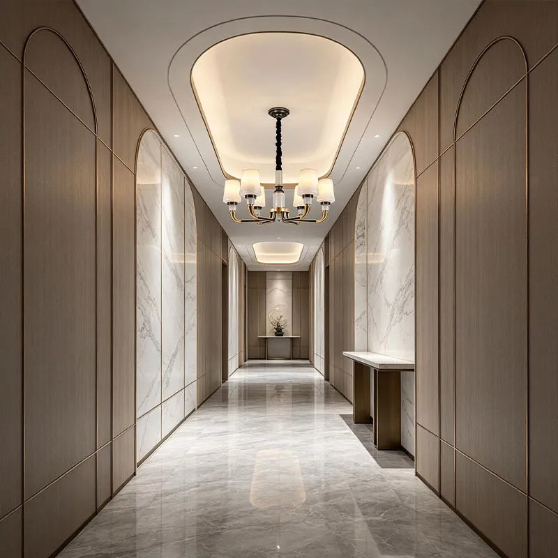 Black brass chandelier installed in a luxury hallway with a classic multi-light design.