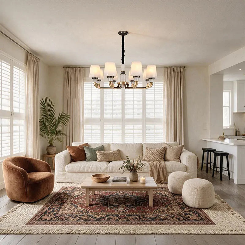 Black brass chandelier featured in a contemporary interior with warm lighting and classic style.