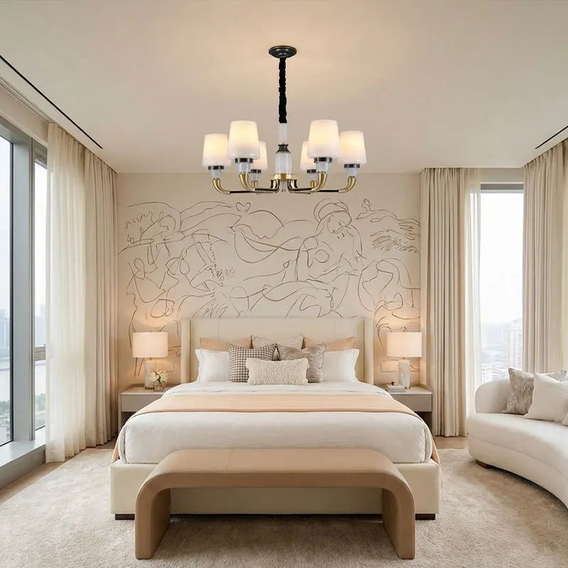 Black brass chandelier hanging in a modern bedroom with multiple candle-style lights and fabric shades.