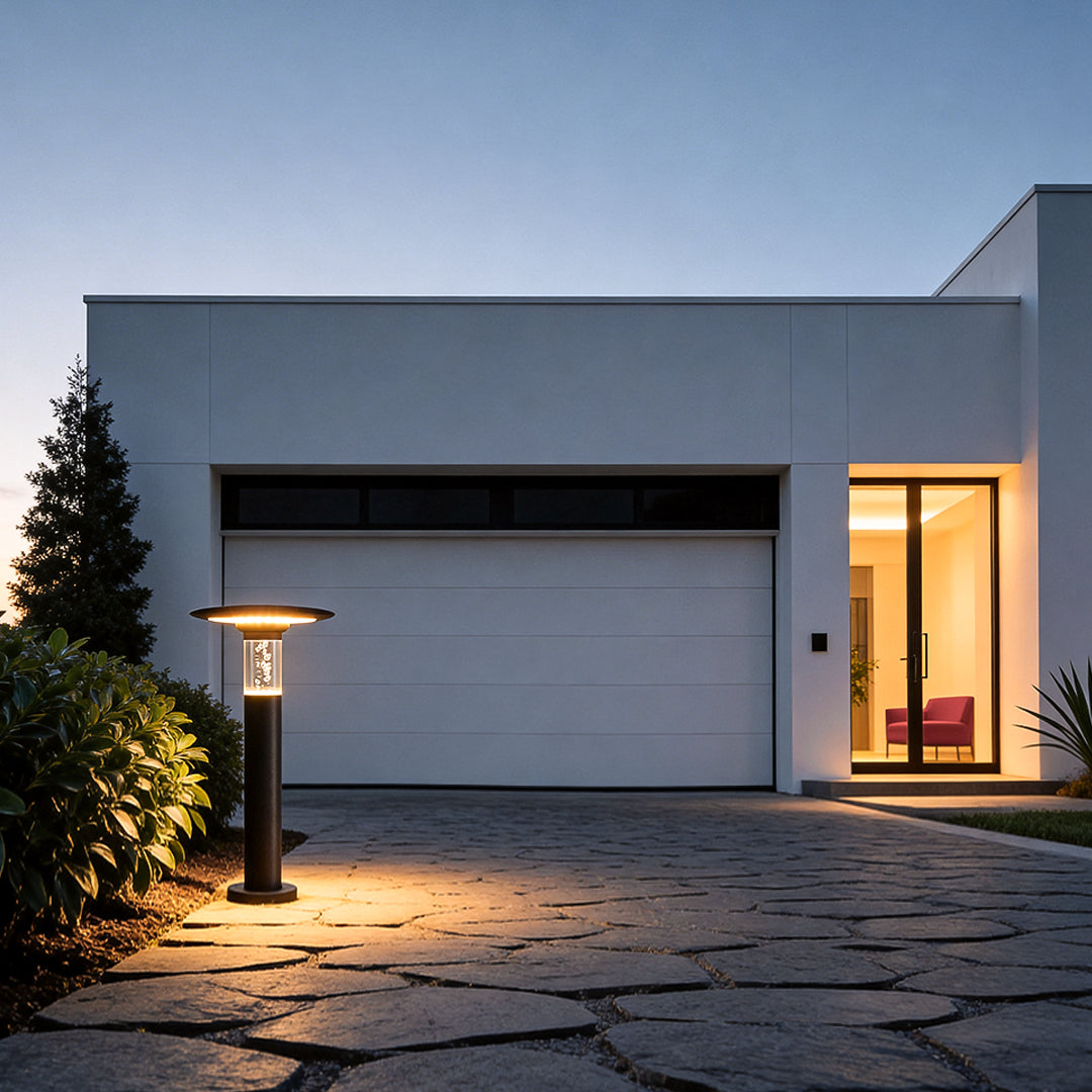Black brass path lights enhancing a contemporary house entrance with elegant ambient light.