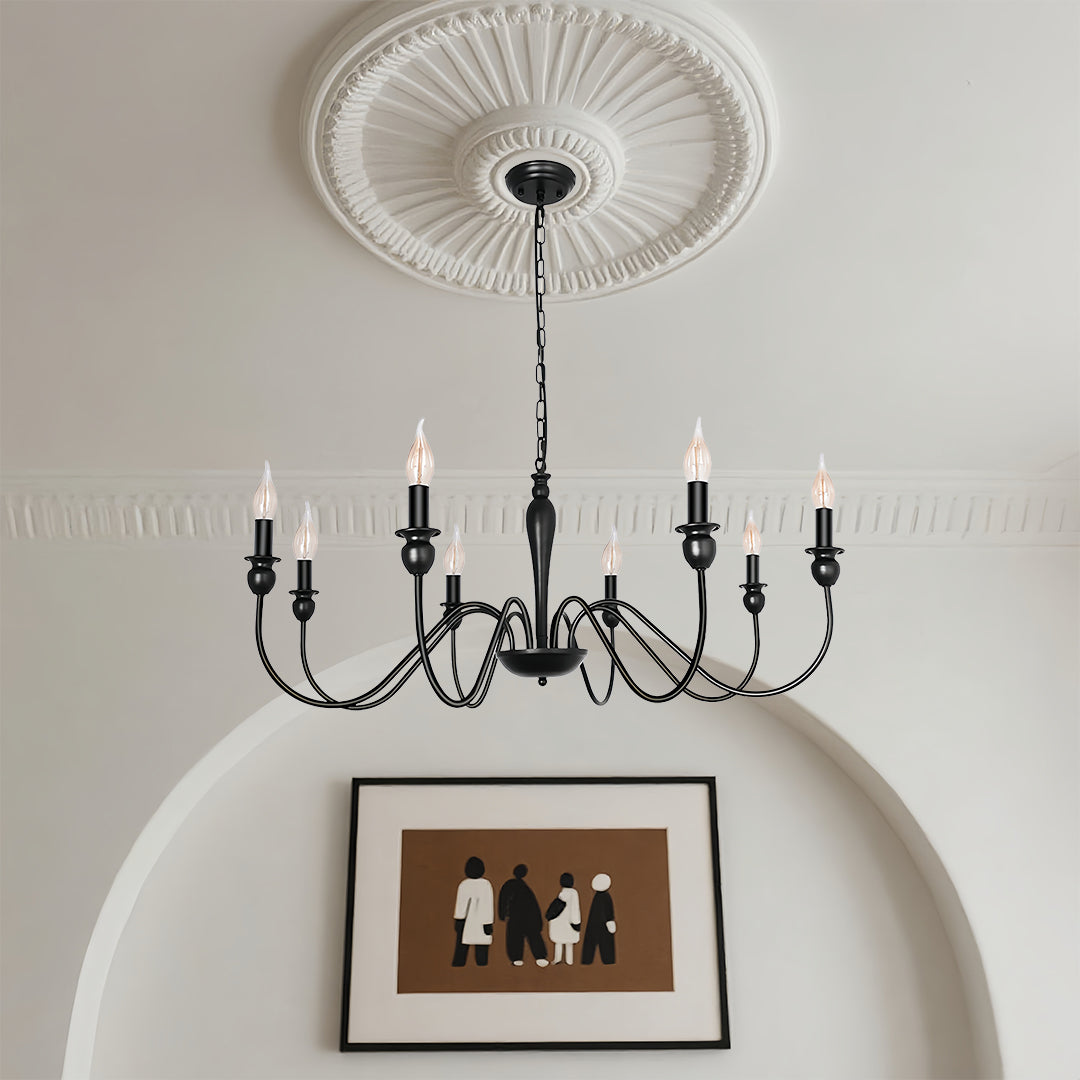 Black candle chandelier installed above dining table with decorative ceiling medallion in elegant room setting