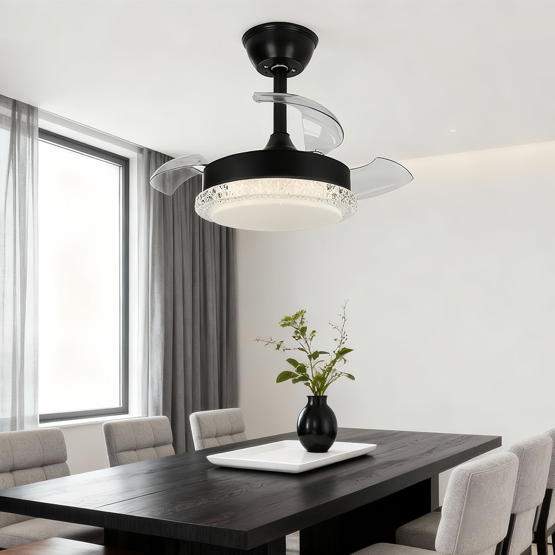 Black ceiling fan with light and retractable blades installed above dark dining table in bright minimalist room with grey curtains.