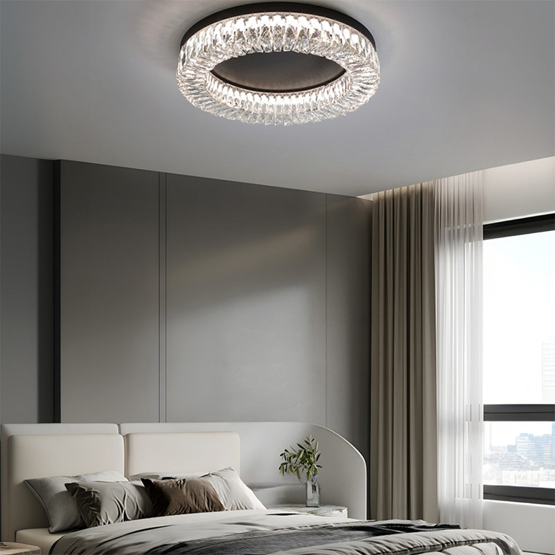 Black ceiling flush mount light brightening contemporary bedroom with beige tones and modern furnishings.