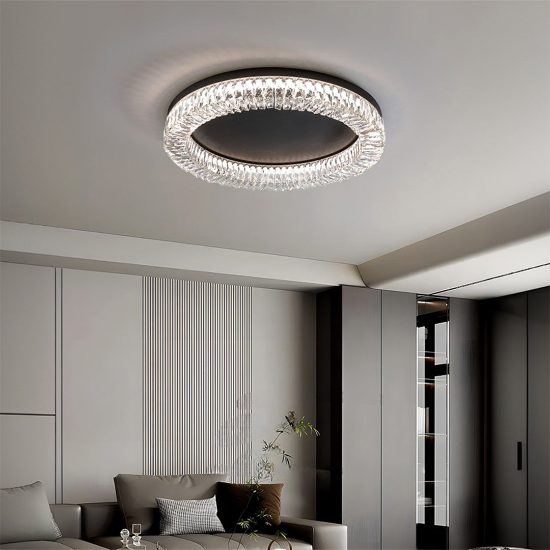 Black ceiling flush mount light illuminating spacious bedroom with white curtains and minimalist decor.