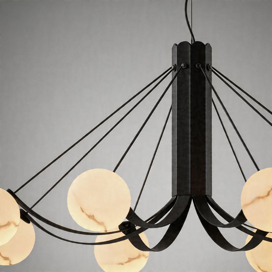 Close-up detail of black chandelier arms and frosted globe bulbs with sleek matte finish.