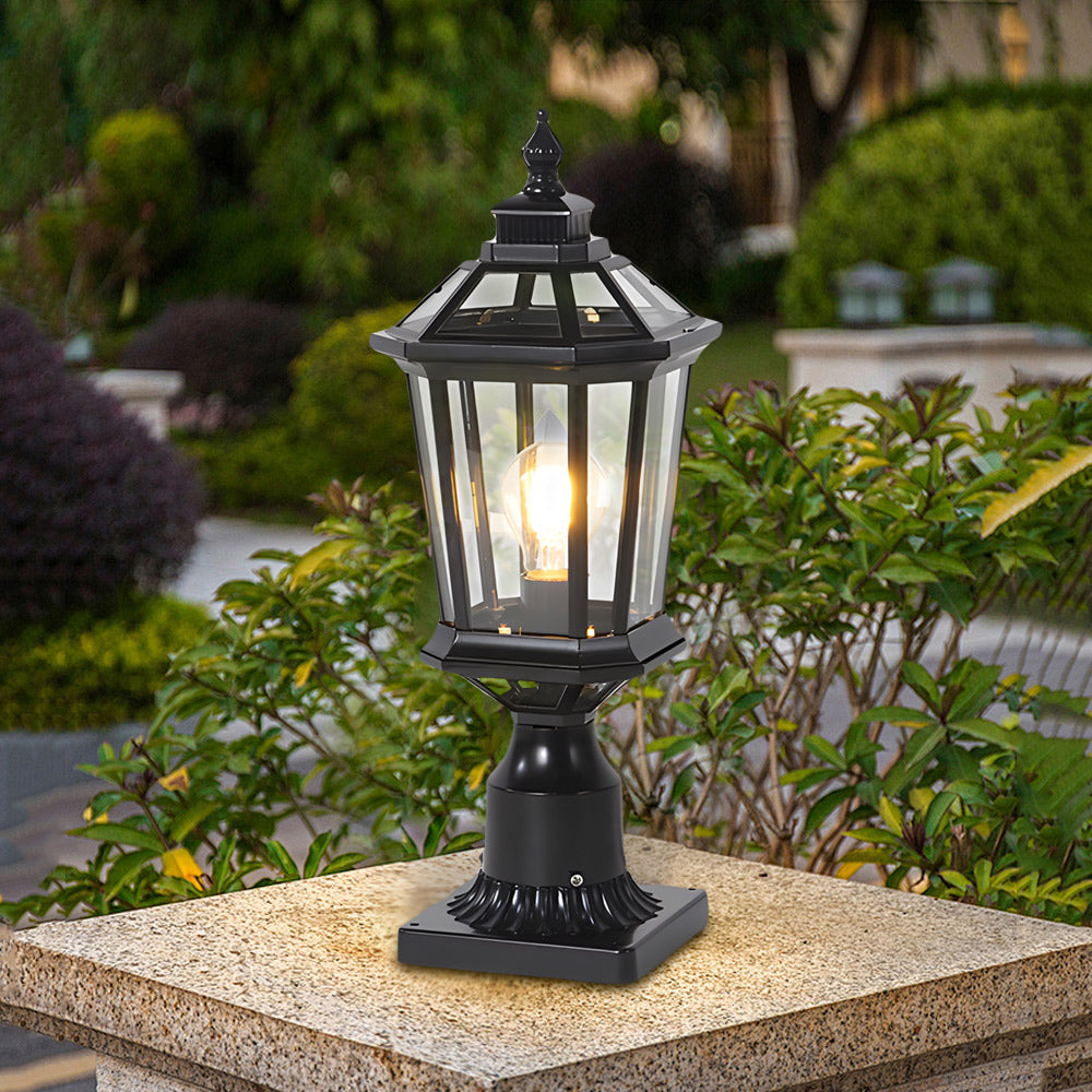 Elegant black column lantern positioned among landscaping providing decorative accent lighting for garden areas