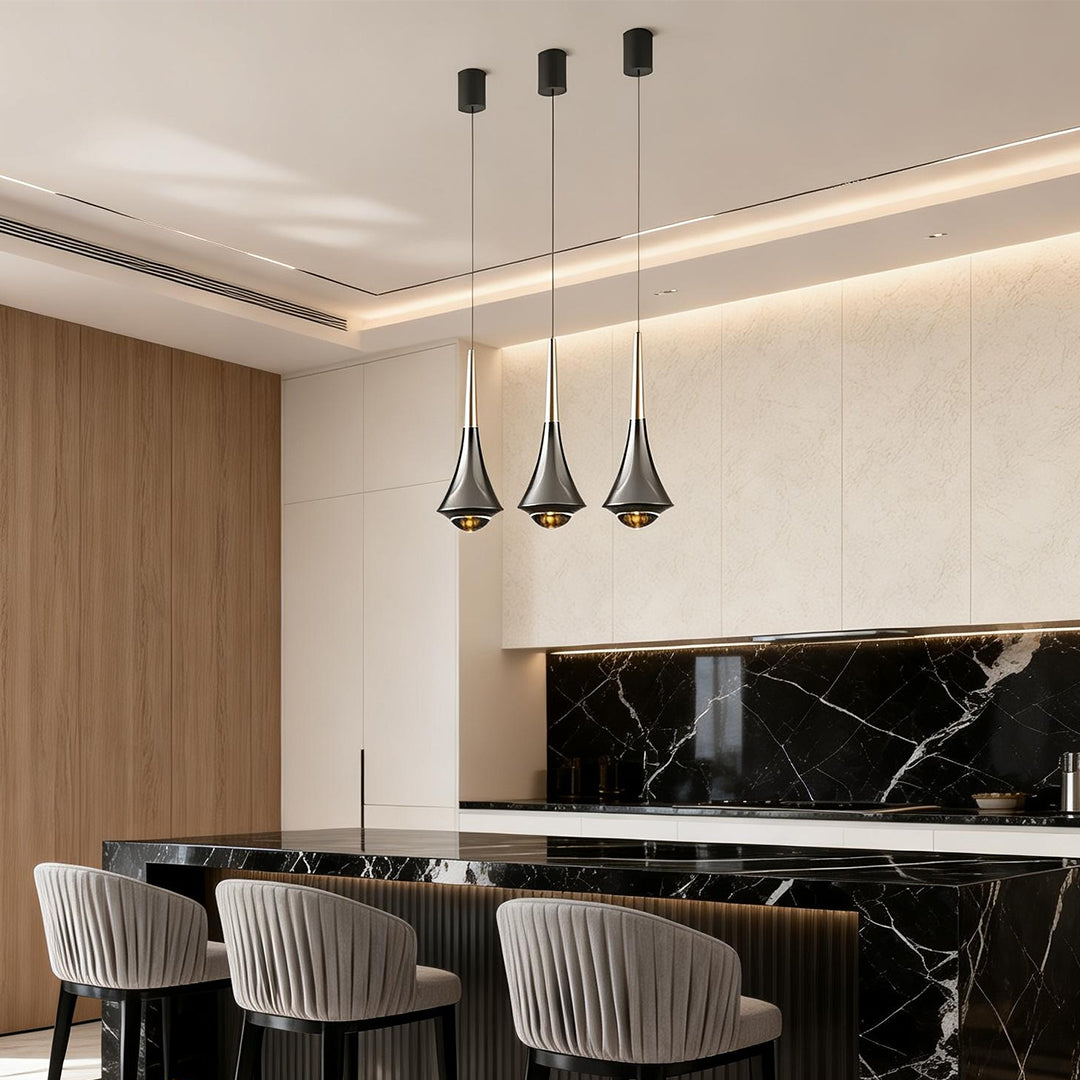 Minimalist black cone pendant lights hanging in a contemporary open kitchen with marble accents.