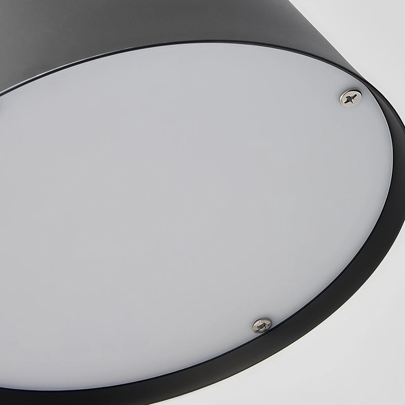 Black cone wall sconce close-up highlighting the white diffuser beneath the wide tapered shade.