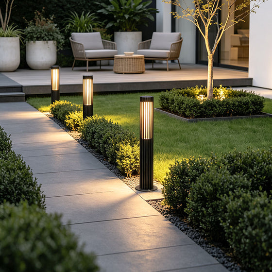 Modern black contemporary bollard lighting fixture with vertical slatted cylindrical outdoor design.