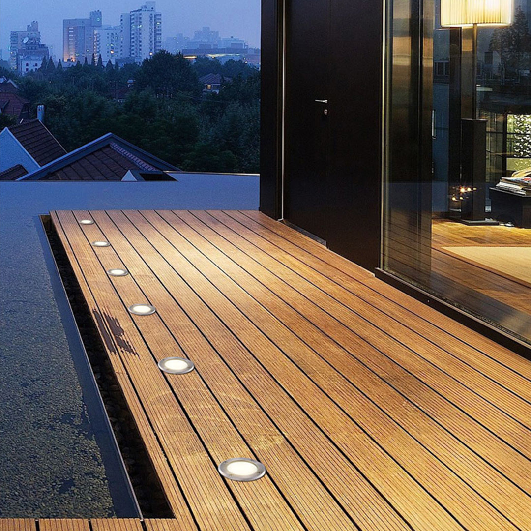 Modern in-ground light fixture with prismatic lens and metal housing for landscape accent lighting