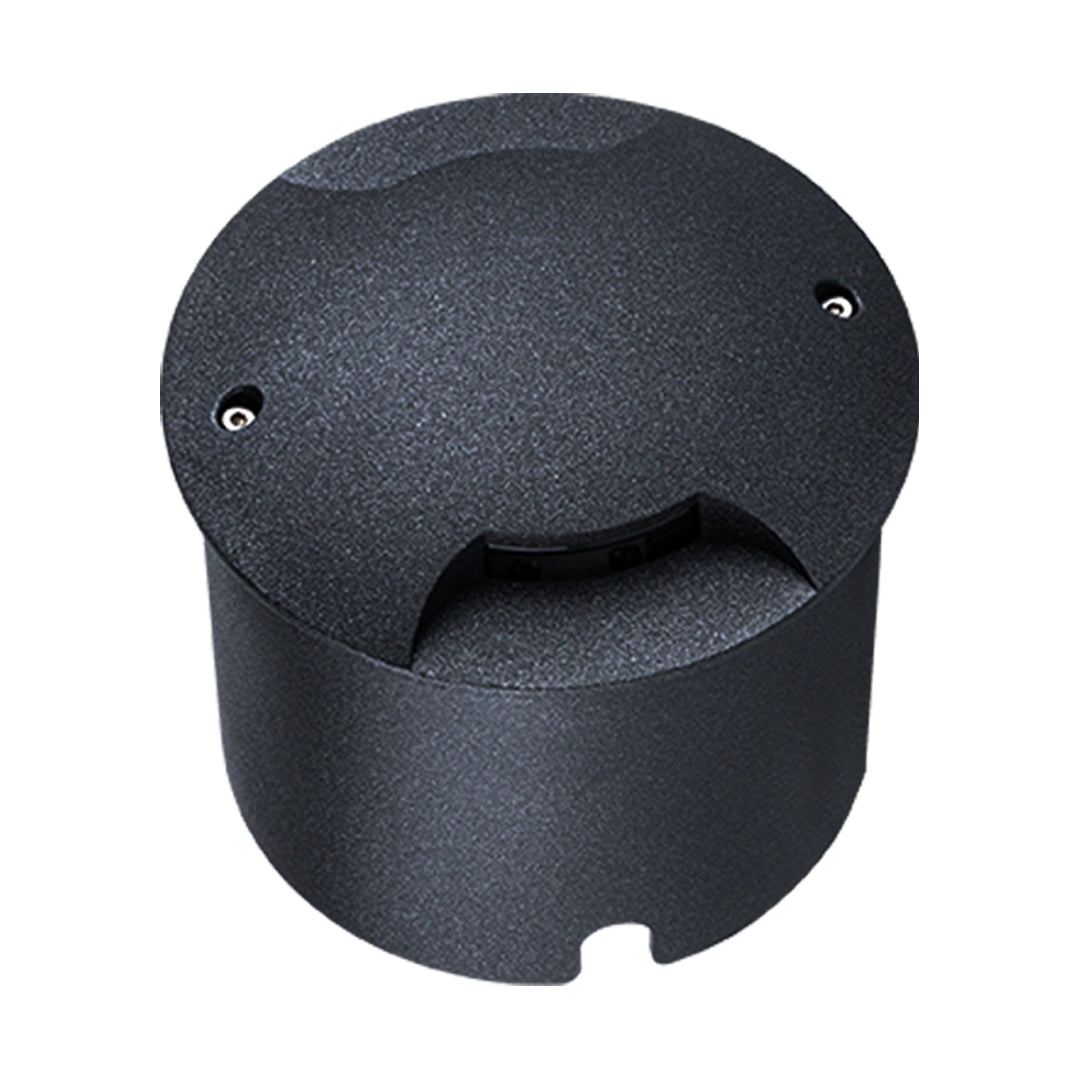 Round black recessed ground light with side-facing aperture for directional illumination