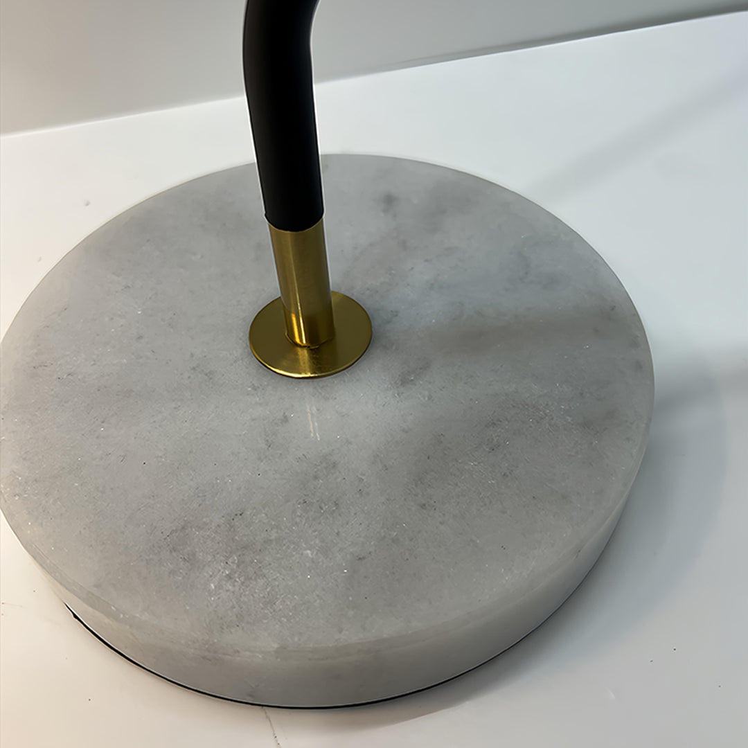 Close-up view of black desk lamps base showing marble texture and brass accent details
