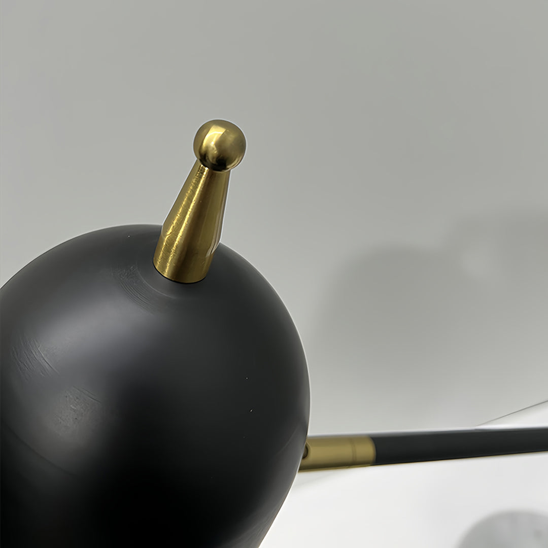 Detail shot of black desk lamps head highlighting brass connection and matte finish