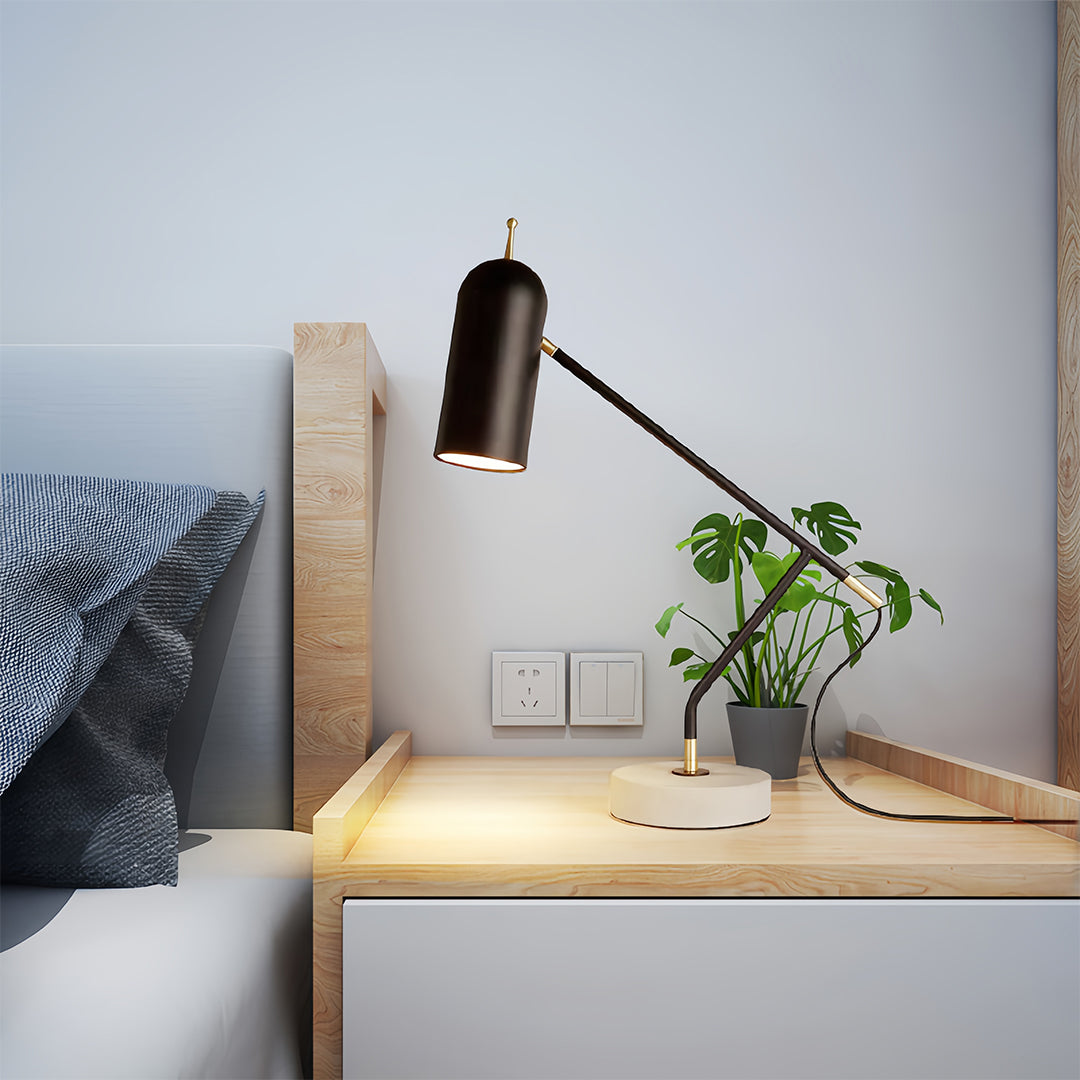 Black desk lamps positioned on wooden desk providing focused task lighting for workspace