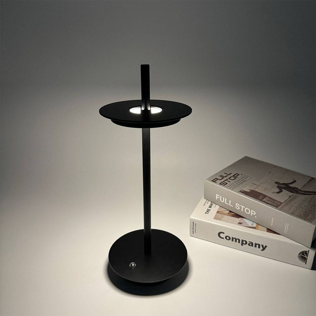 Black dimmable table lamp providing focused task lighting in contemporary workspace setting