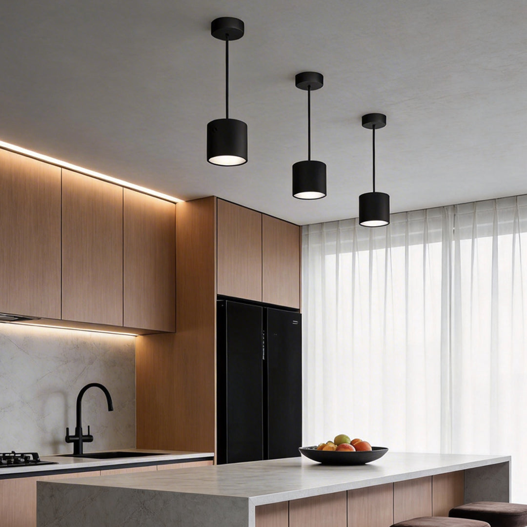 Black drum pendant light enhancing a contemporary kitchen island with elegant directional light.
