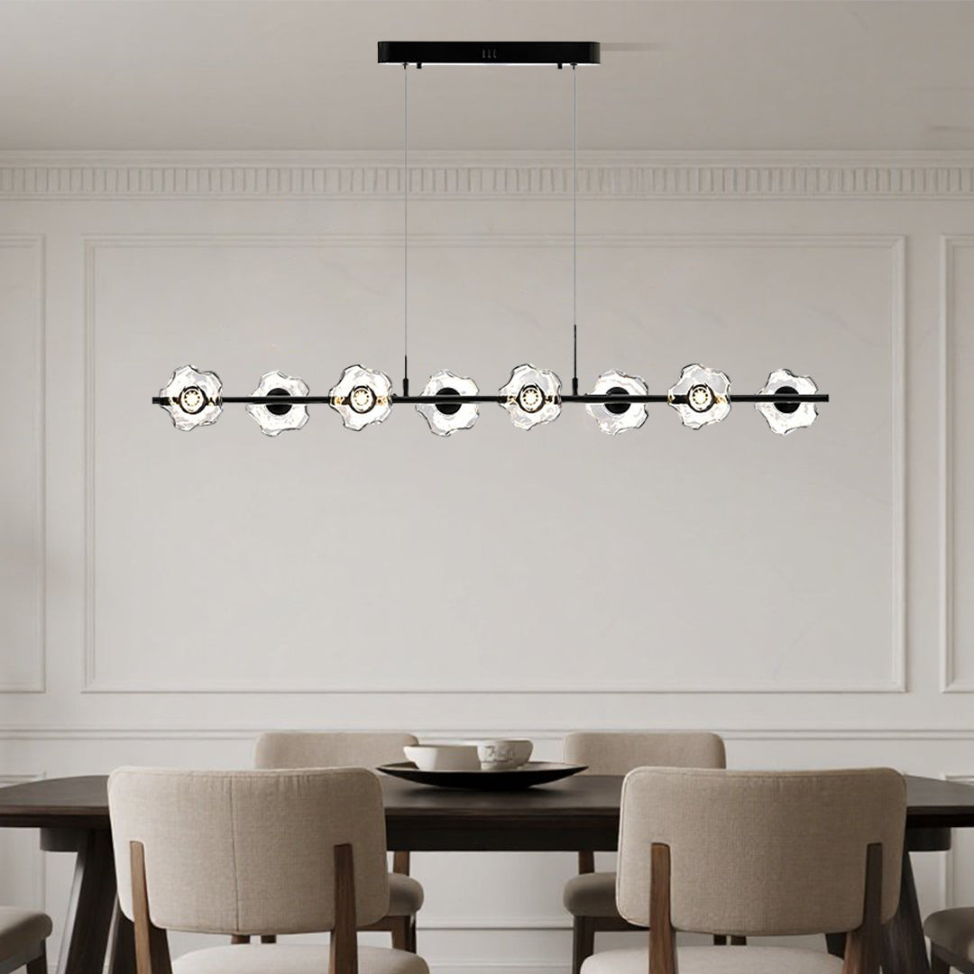 Sleek linear pendant chandelier with black finish enhancing minimalist dining room with horizontal glass design
