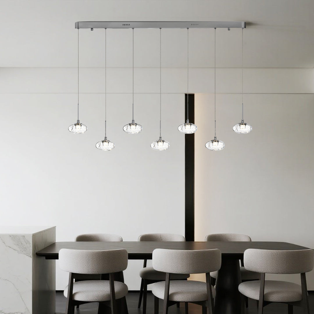 Multi light pendant lighting with black finish providing stylish task lighting in minimalist dining room setting