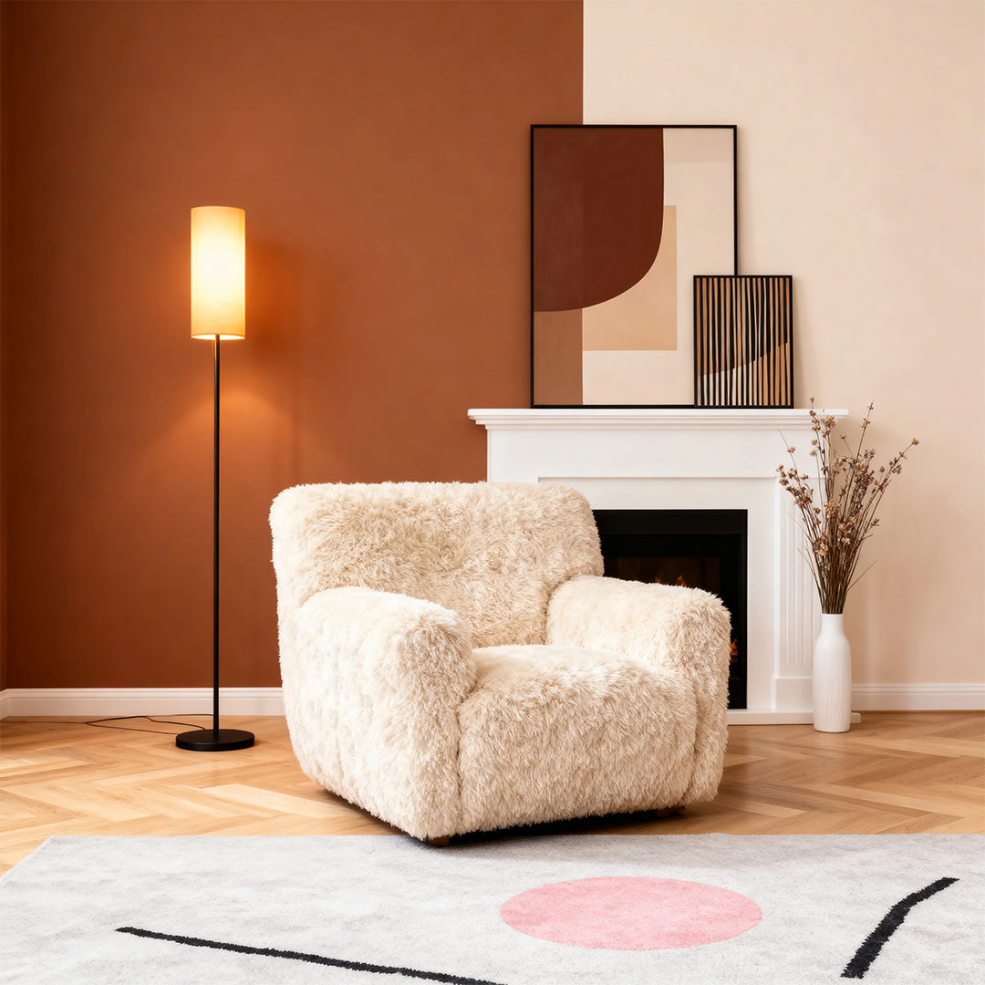 Black wrought iron floor lamps creating warm glow in modern setting with sherpa chair accent