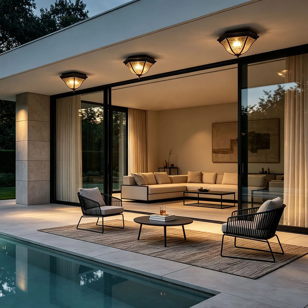 Black flush mount light fixtures installed along a modern covered patio beside a swimming pool.
