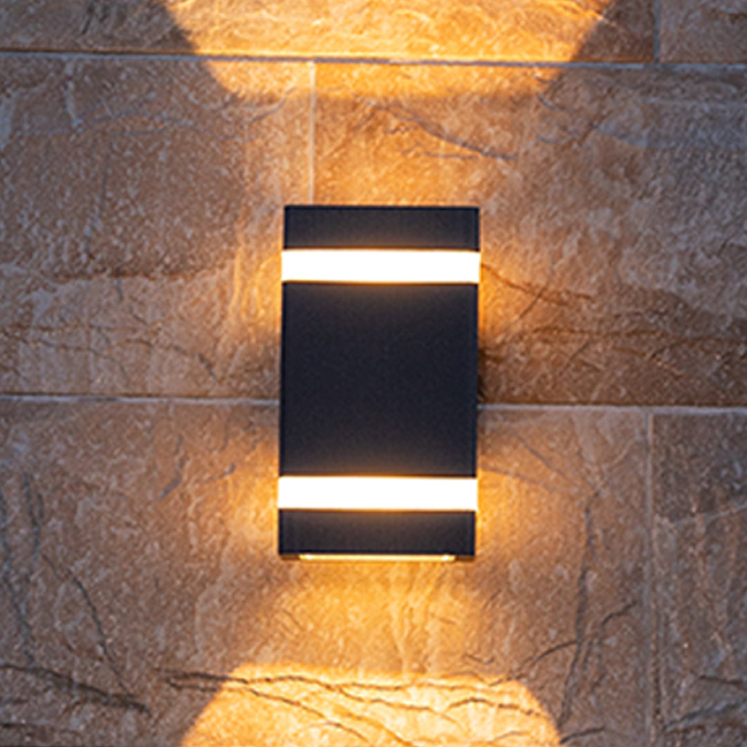 Black garden wall light with horizontal white accent creating up-down light effect