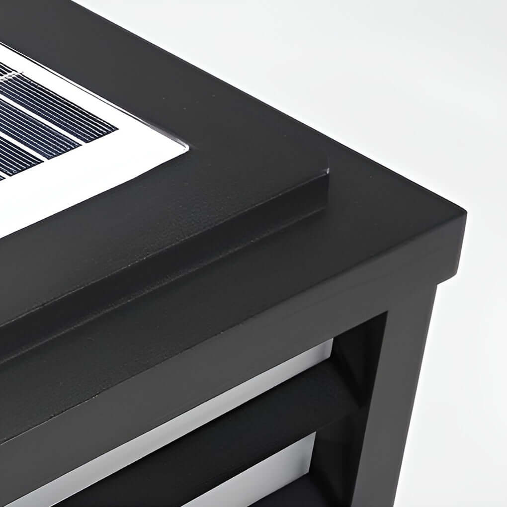 Black gate pillar light with a rectangular shape, providing bright illumination near a garden entrance.