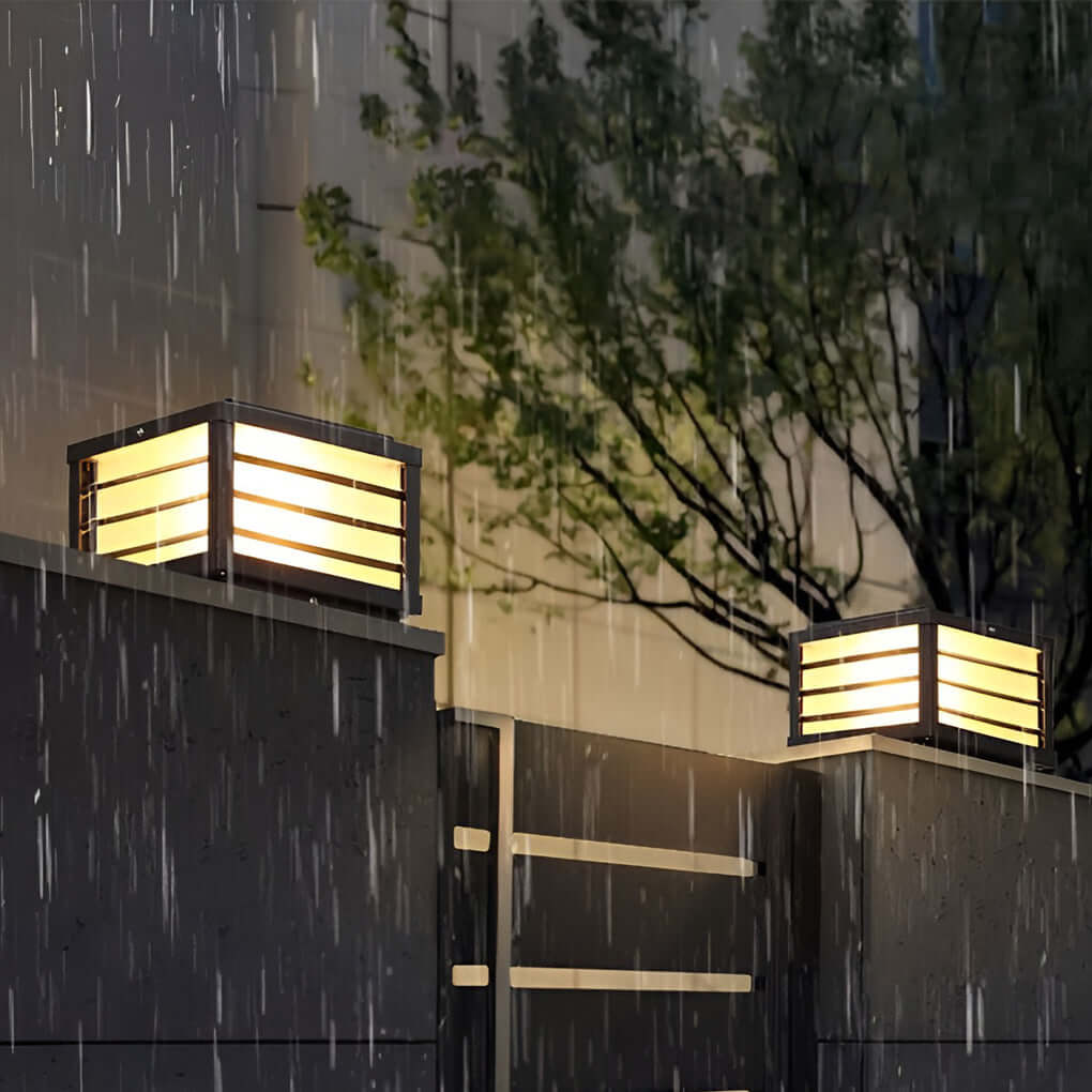 Black gate pillar light with a rectangular design, showcasing water droplets for durability in rainy weather.