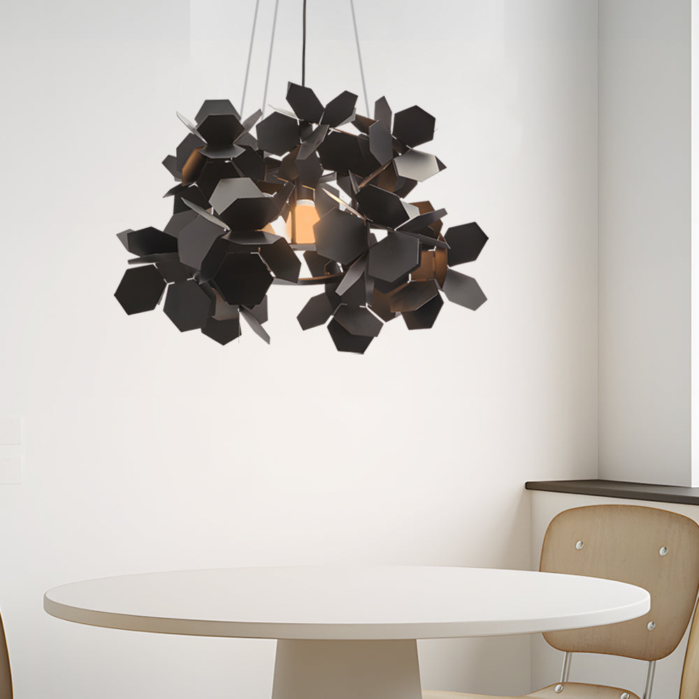 Black geometric chandelier with a leaf-inspired design, providing ambient lighting in a stylish kitchen.