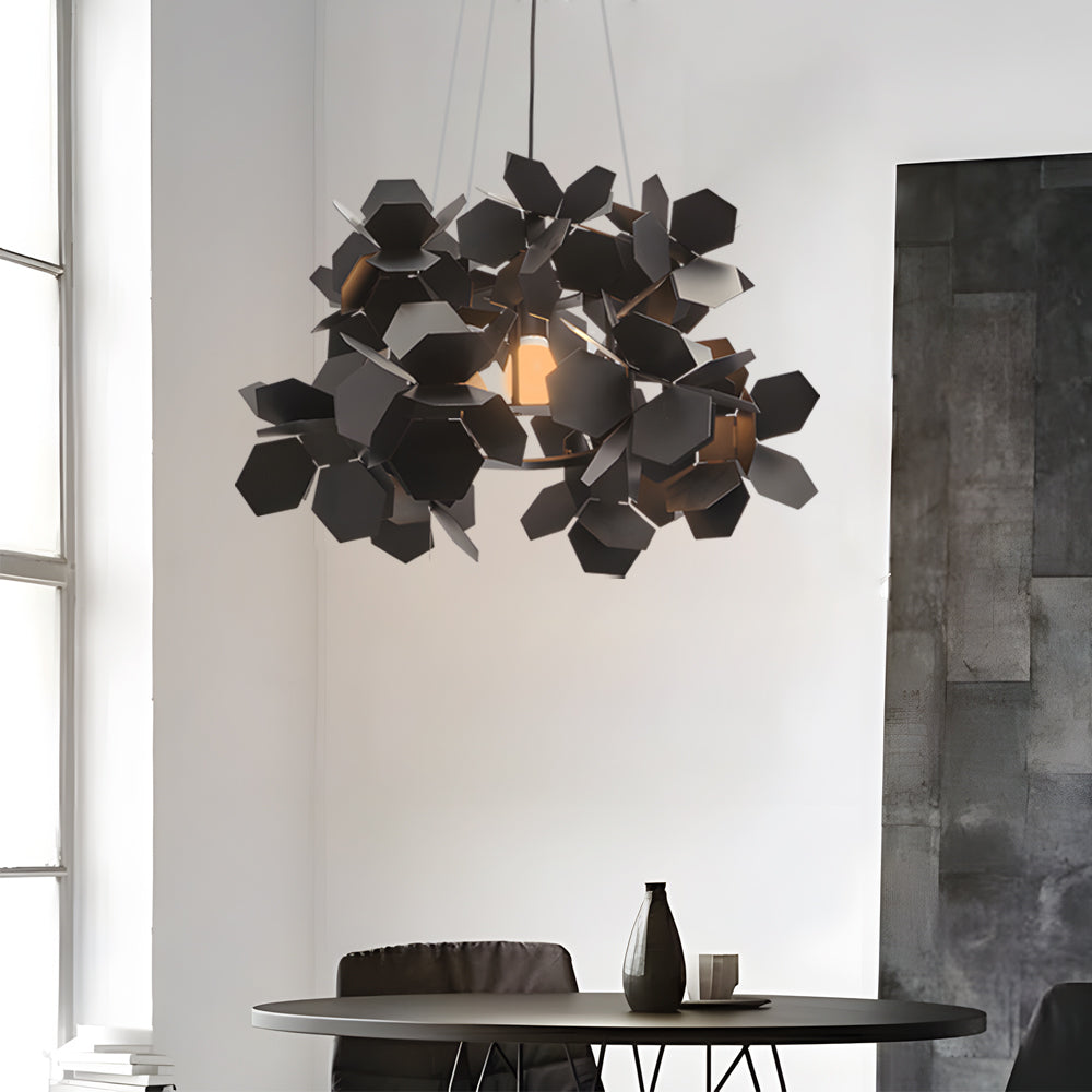 Black geometric chandelier with a leaf-inspired design, enhancing a modern interior.