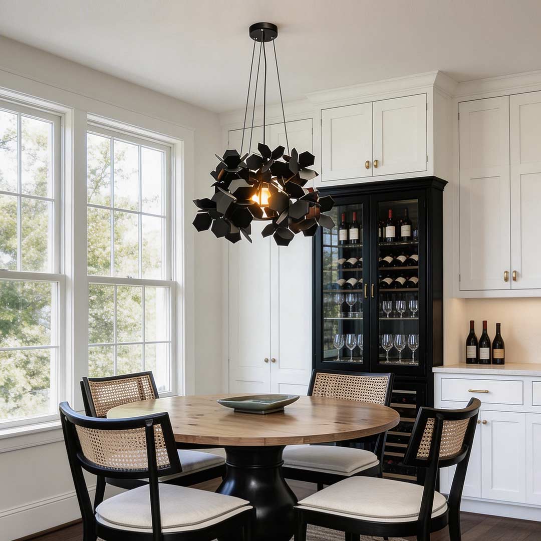 Black geometric chandelier with a unique leaf design, illuminating a contemporary dining room.