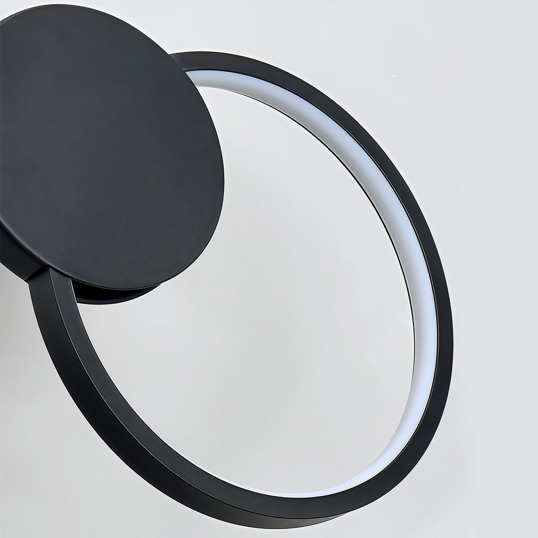 Close-up detail of black geometric pendant light circular ring structure.